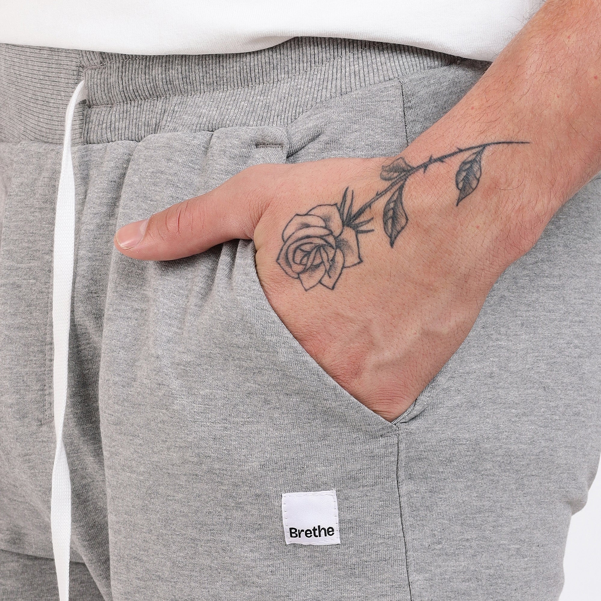 Brethe Free Form Jogger in Heather Grey close-up showing side pocket with Brethe logo label.