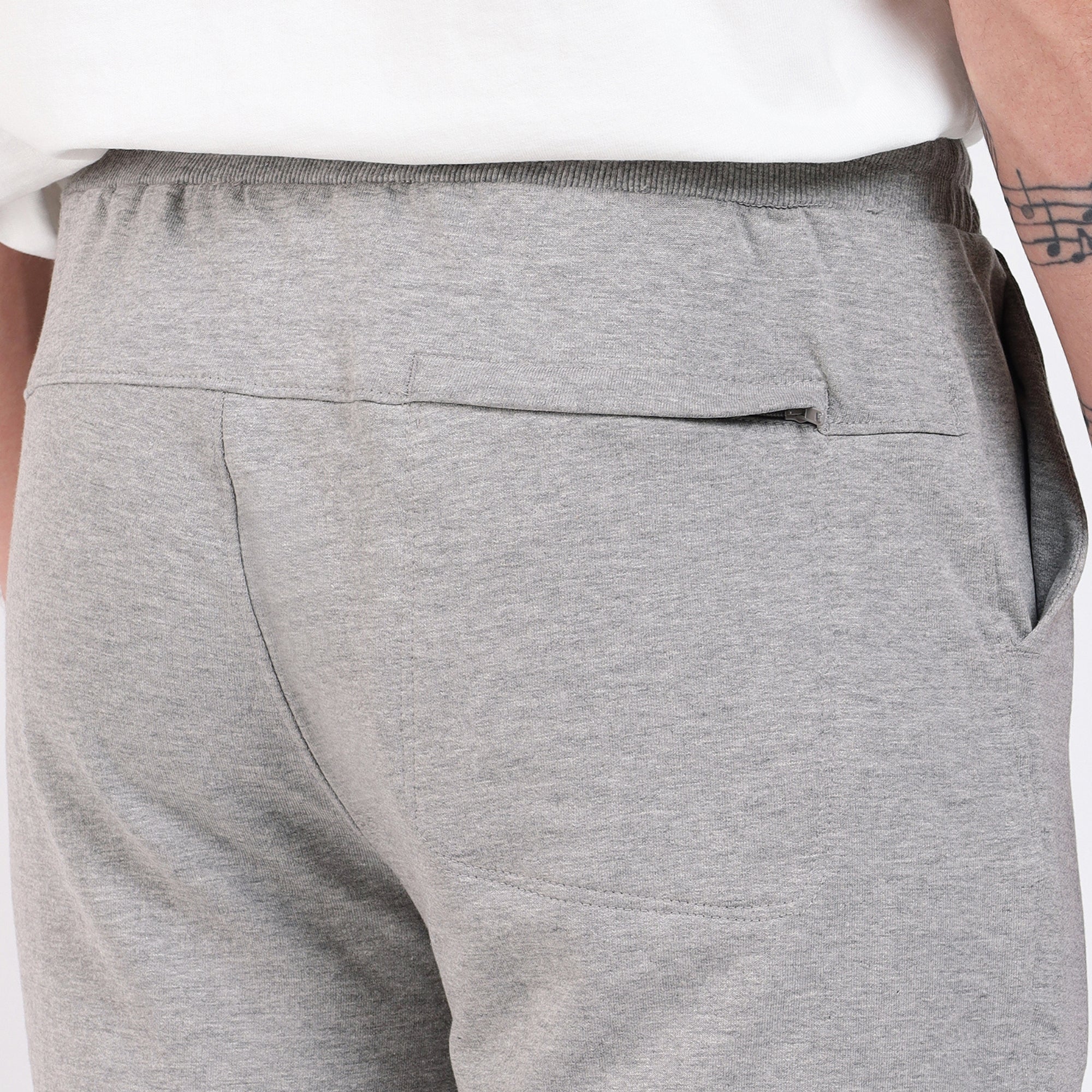 Brethe Free Form Jogger in Heather Grey back view close-up showing yoke and back pocket.