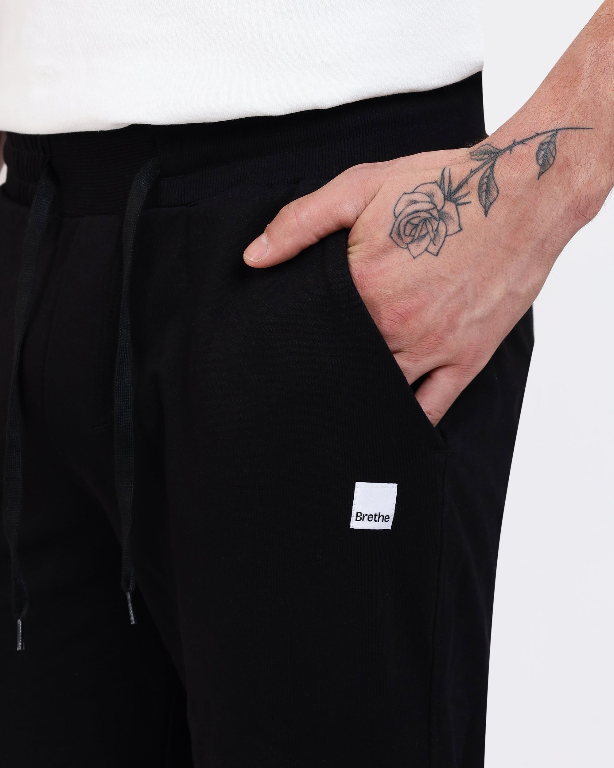 Brethe Free-Form Jogger in Black close-up of side pocket with Brethe logo patch.