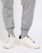 Brethe Free Form Jogger in Heather grey showing ribbed cuff leg opening with sneakers.
