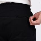 Brethe Soft-Structured Pant black back view showing zip pocket and waistband.
