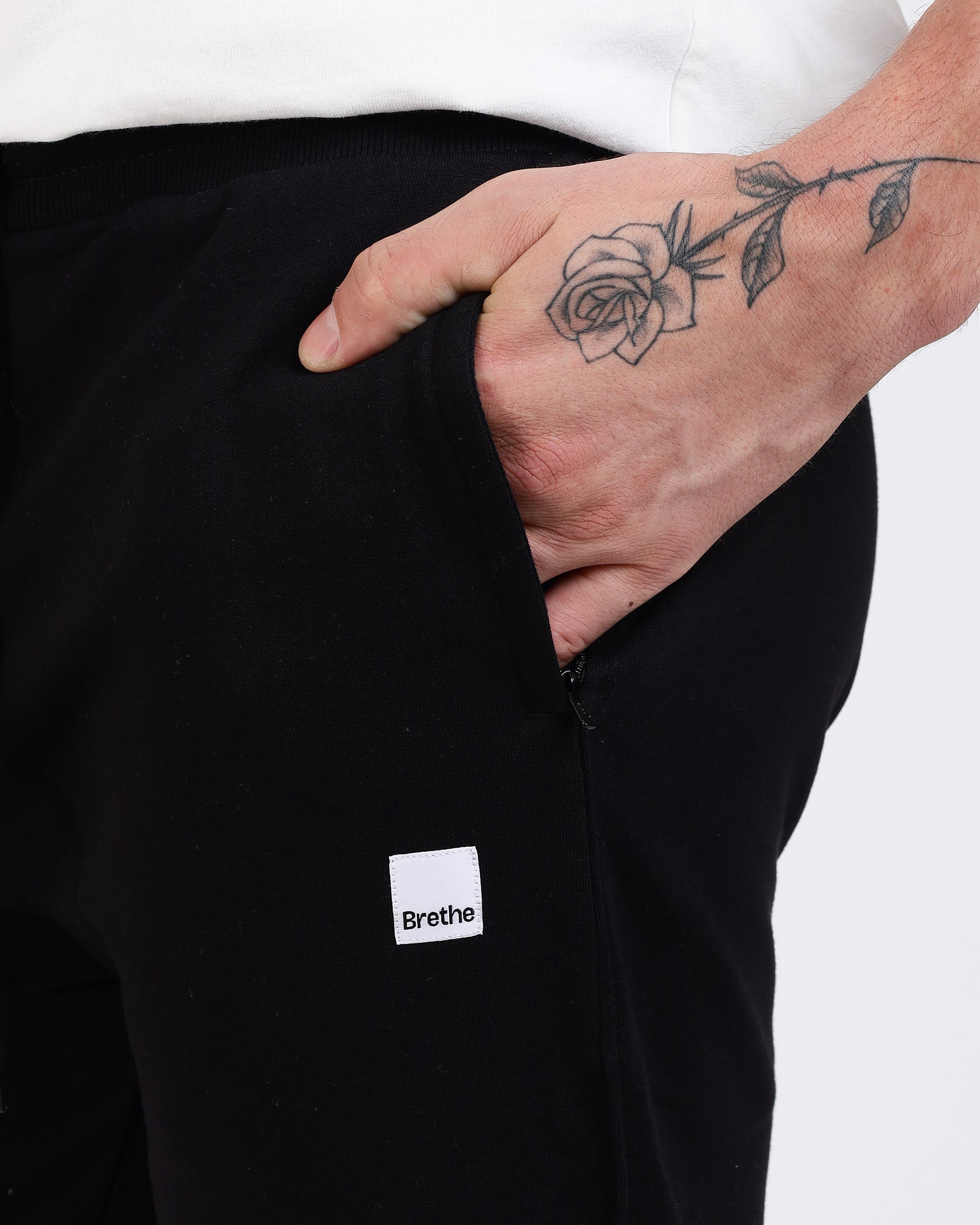 Brethe Soft-Structured Pant worn by a model in Black close-up of side pocket with Brethe logo label.