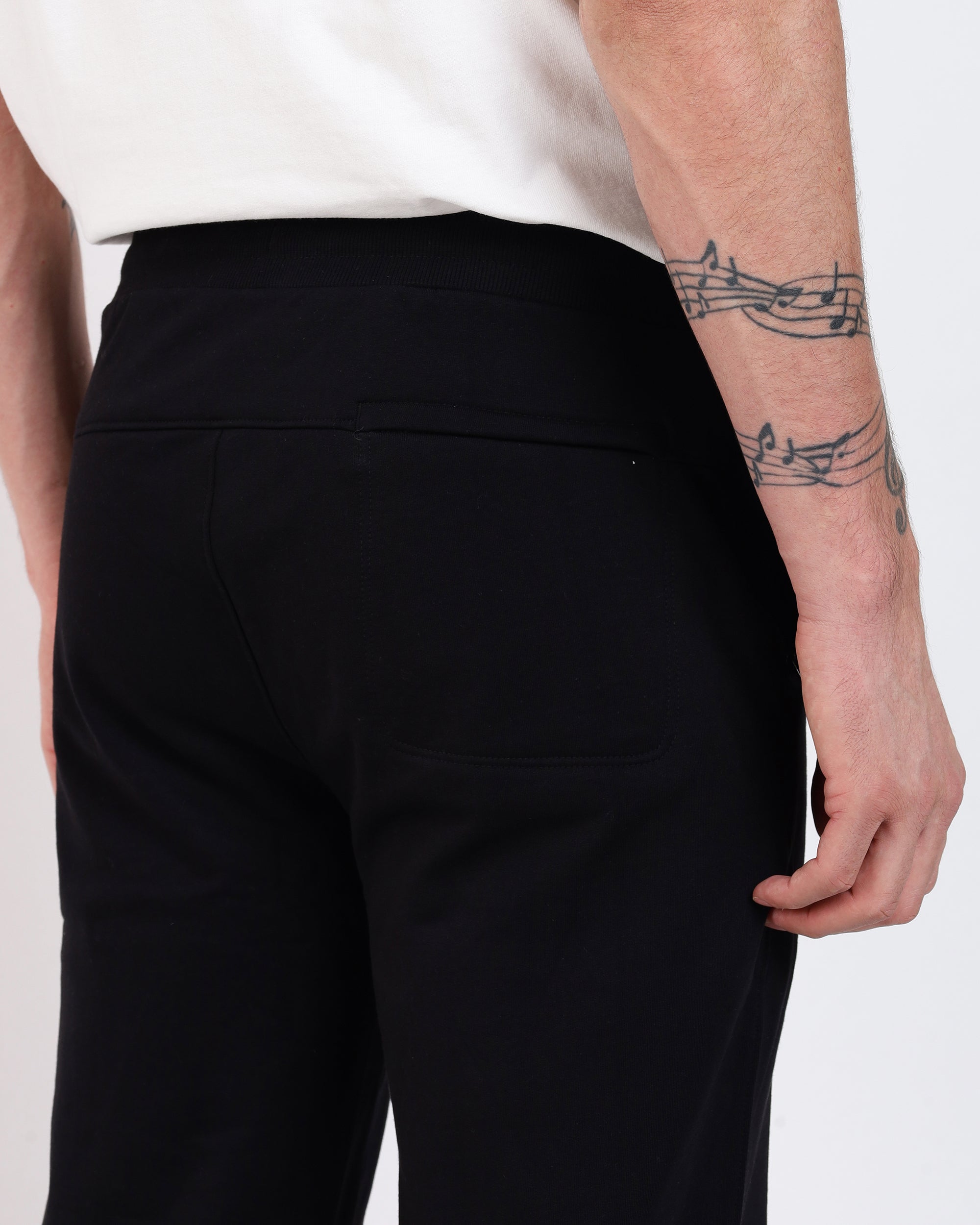 Black Soft-Structured Pant by Brethe, back view showing yoke, back pocket, and ribbed waistband.