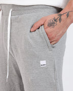 Brethe Soft-Structured Pant worn by a model in Heather Grey close-up of side pocket with Brethe logo label.